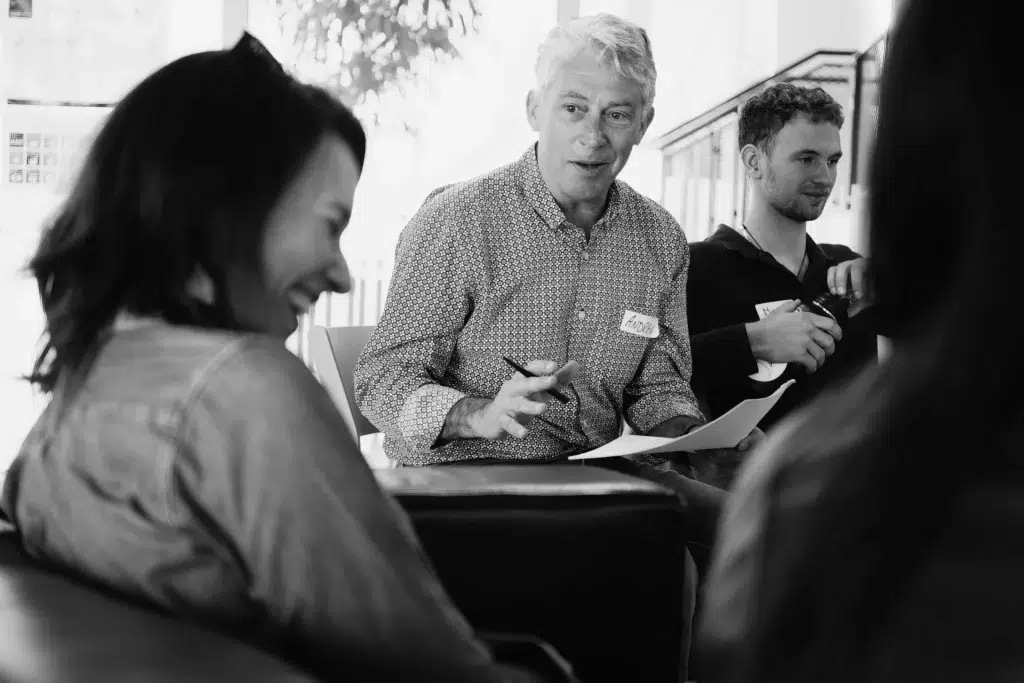 Corporate event photography highlighting an interactive session with engaged participants