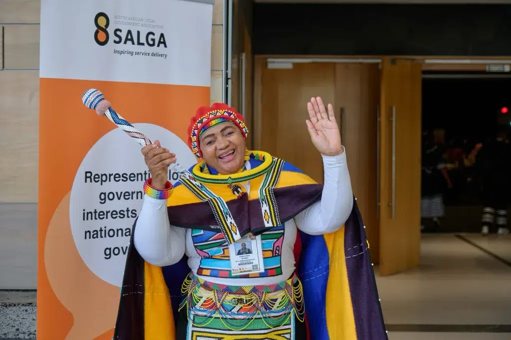 cape-town-event-photography-salga-delegate-traditional-dress Enthusiastic SALGA delegate in traditional South African attire at SALGA event, captured by Cape Town event photographer