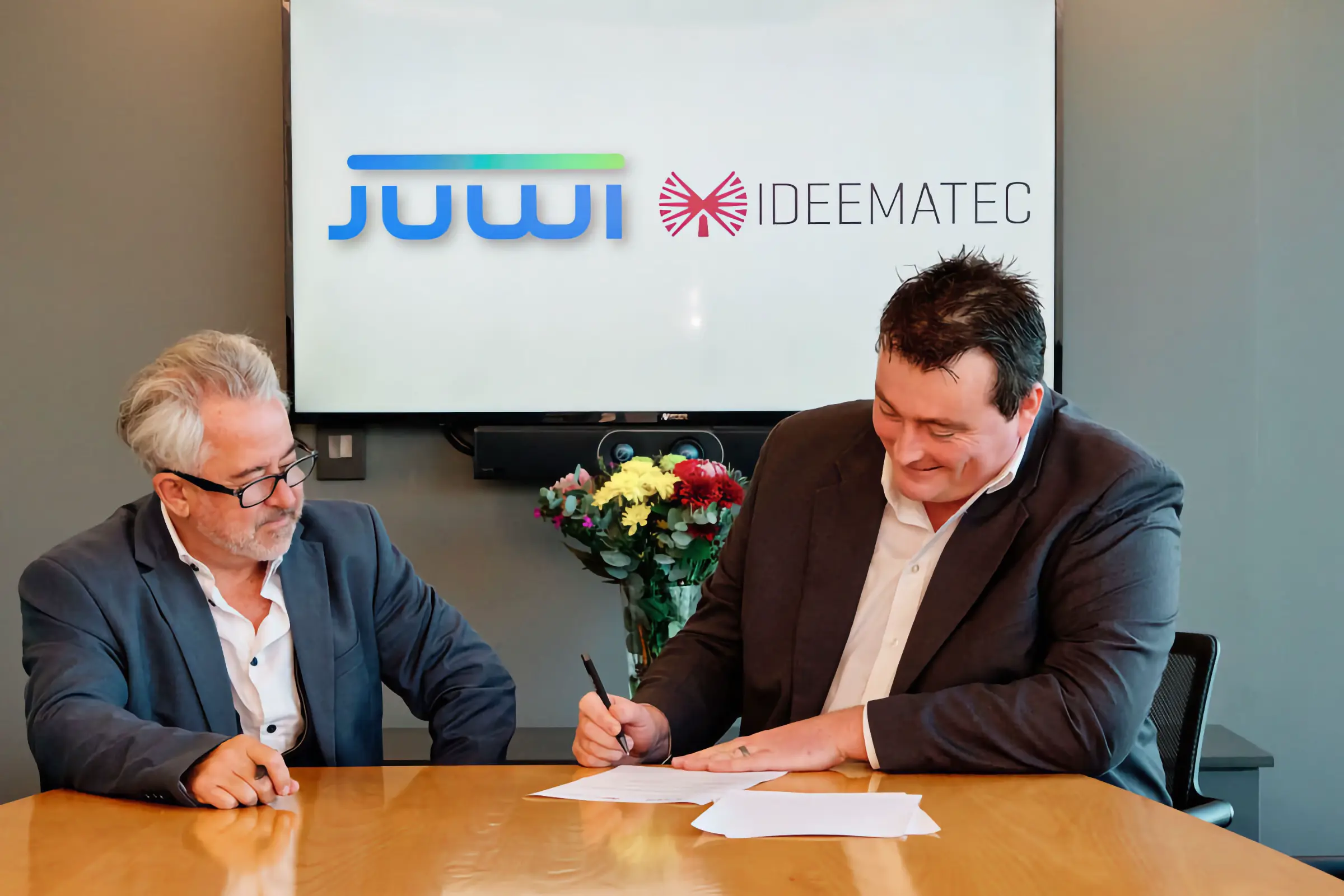 A key business milestone captured through professional corporate event photography, documenting a formal contract signing and successful partnership.